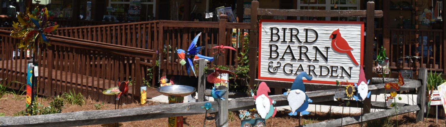 The exterior of a garden supply store with gnomes and bird figurines out front.